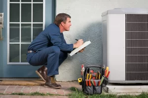 HVAC Technician Diagnosing Air Conditioner